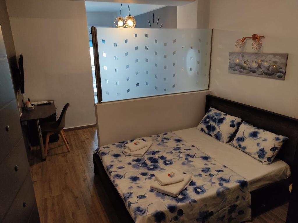 a small bedroom with a bed and a table at Kova2 in Alexandroupoli