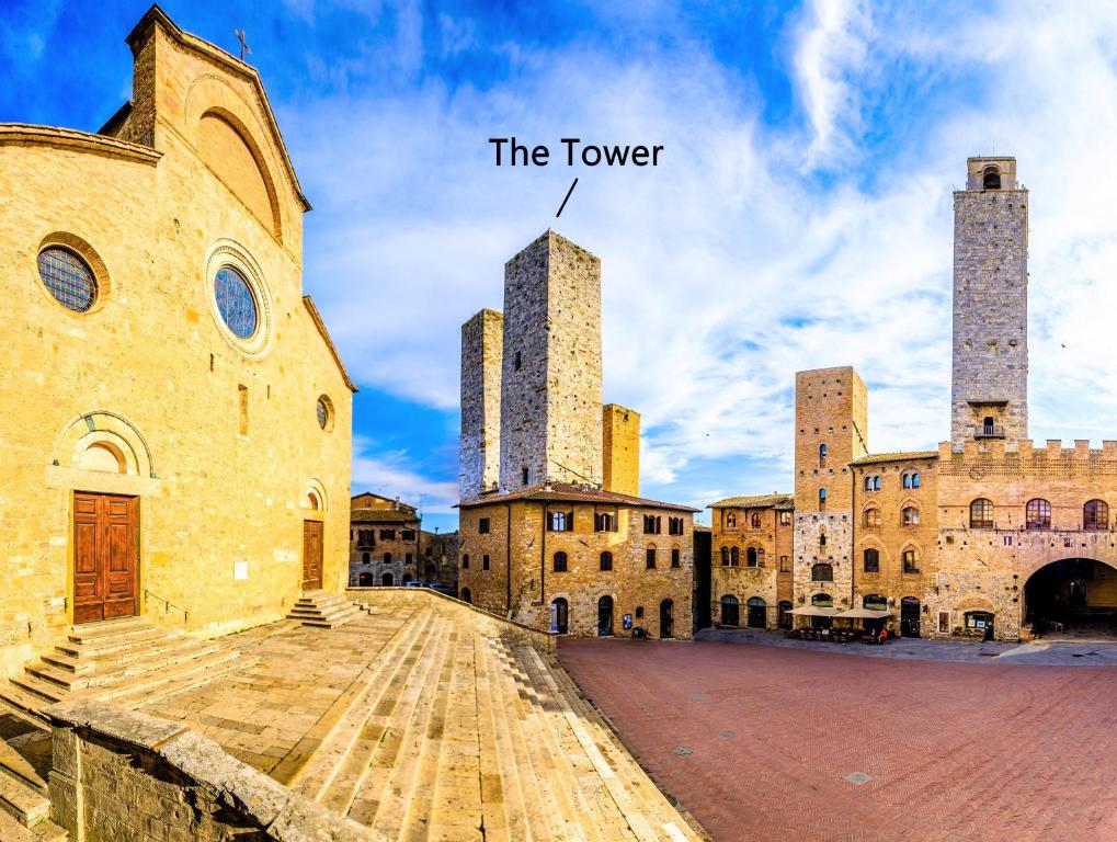 a view of an old building with two towers at Torre Salvucci Maggiore Medieval Tower Experience in San Gimignano