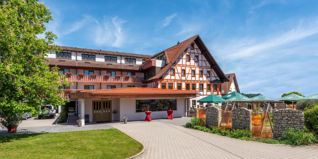 a large building with a courtyard in front of it at Danner´s Hotel Löwen in Marschalkenzimmern