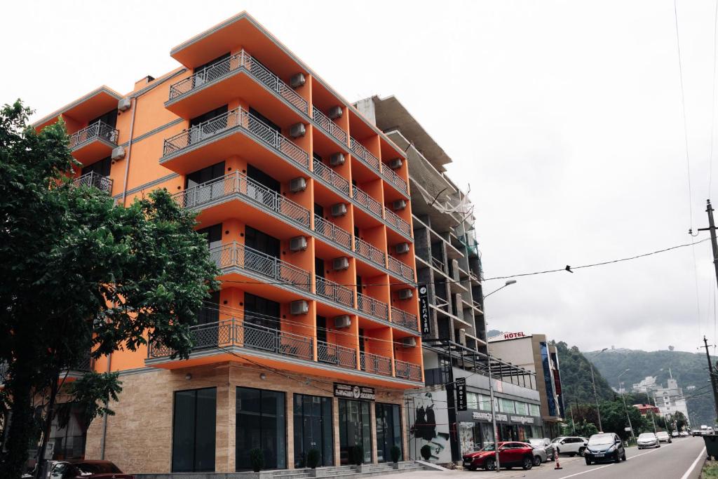 an orange building on the side of a street at Scorpio Hotel Gonio in Gonio