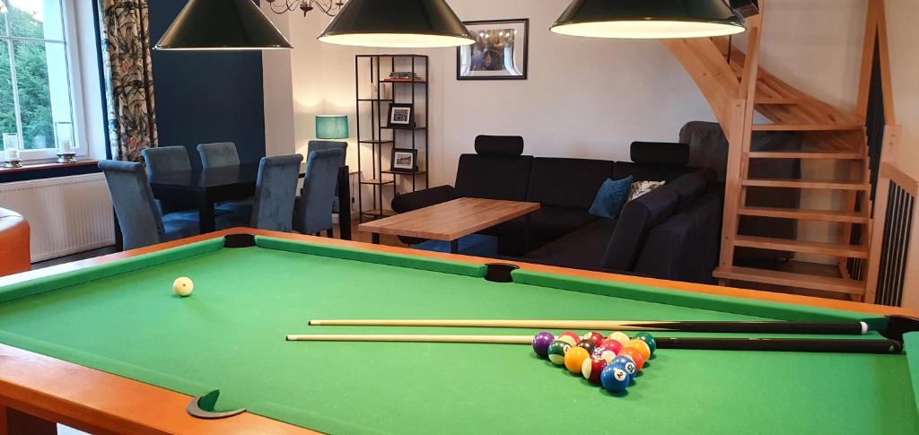 a living room with a pool table with cue balls at Dom w mieście Reszel in Reszel