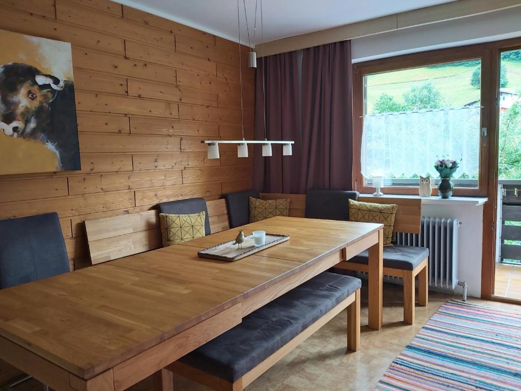 a dining room with a wooden table and chairs at Ferienwohnung Schädler in Schruns