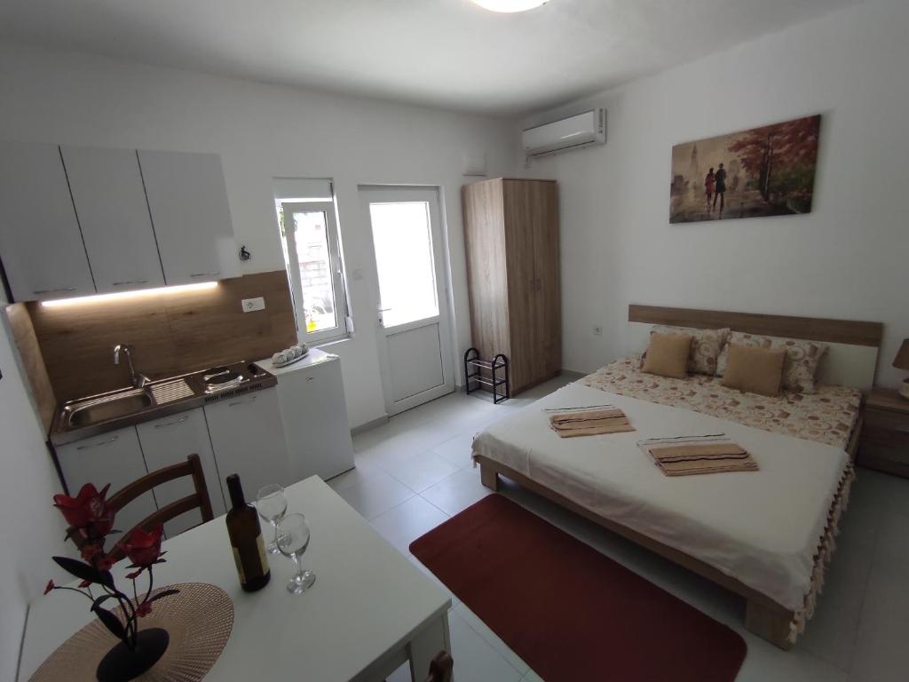 a small room with a bed and a sink at Apartments Željka-Dobrota in Kotor