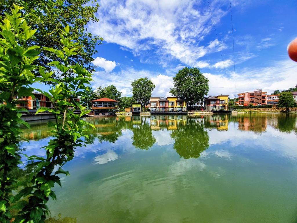 a large body of water with houses in the background at Waterside Houses in Ognyanovo