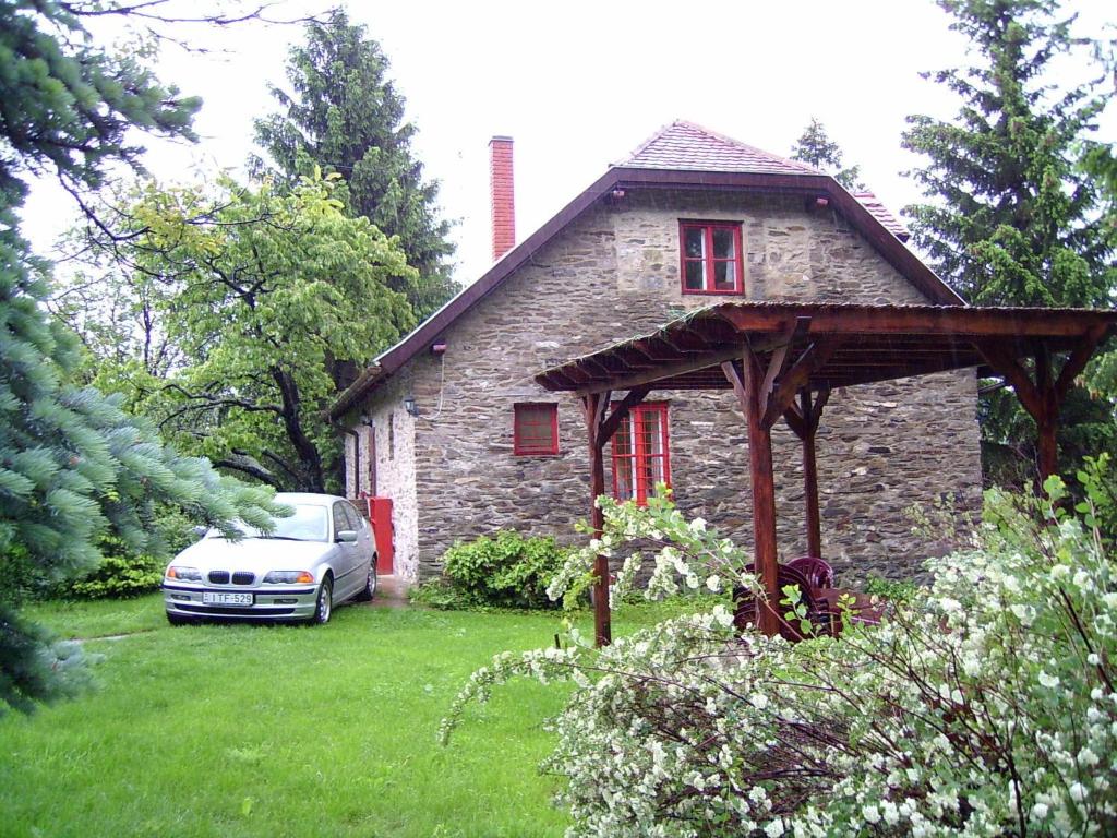 a car parked in front of a stone house at Gereben Villa in Velem