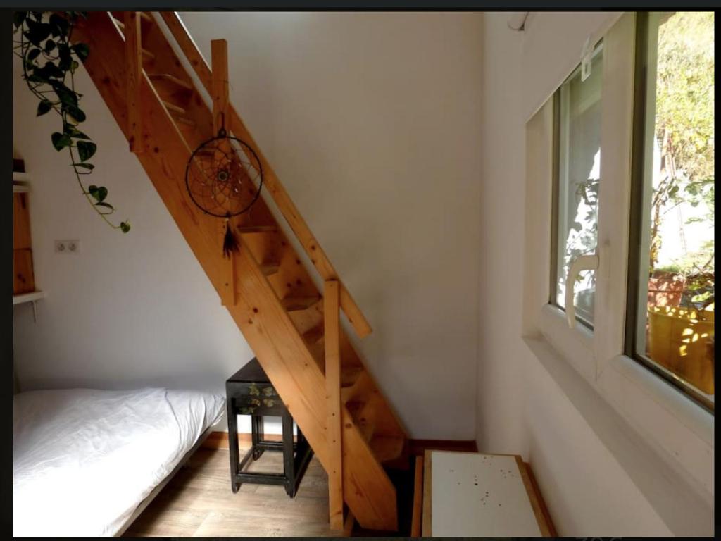 klatka schodowa w pokoju z łóżkiem i oknem w obiekcie Cocon duplex à la ferme w mieście Boutx