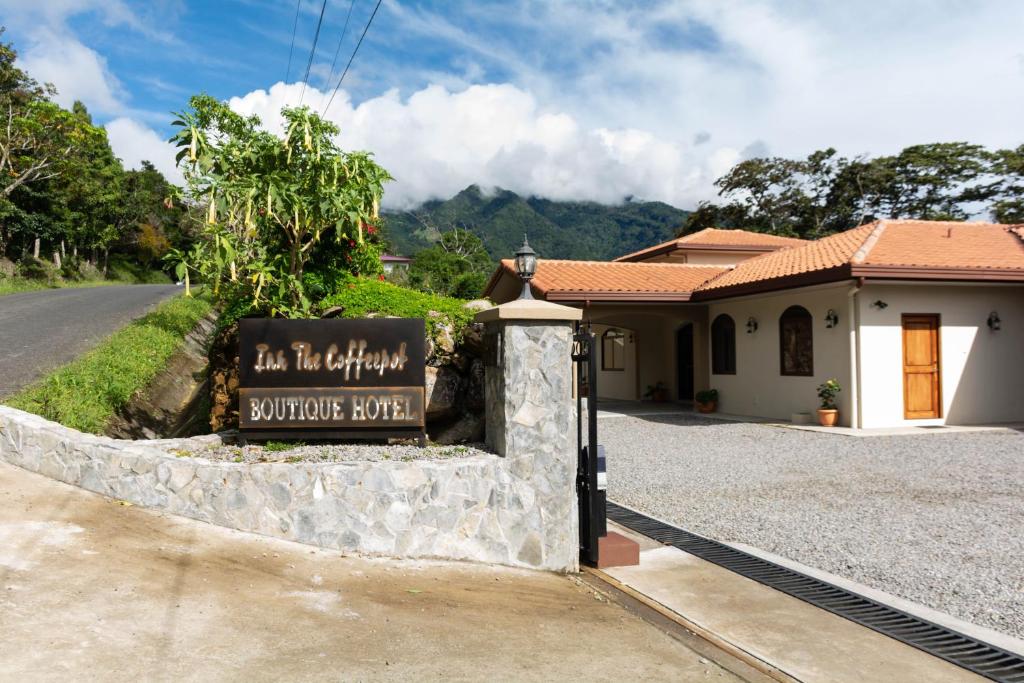 a sign in front of a building on a road at Inn The Coffeepot - Boutique Hotel in Boquete