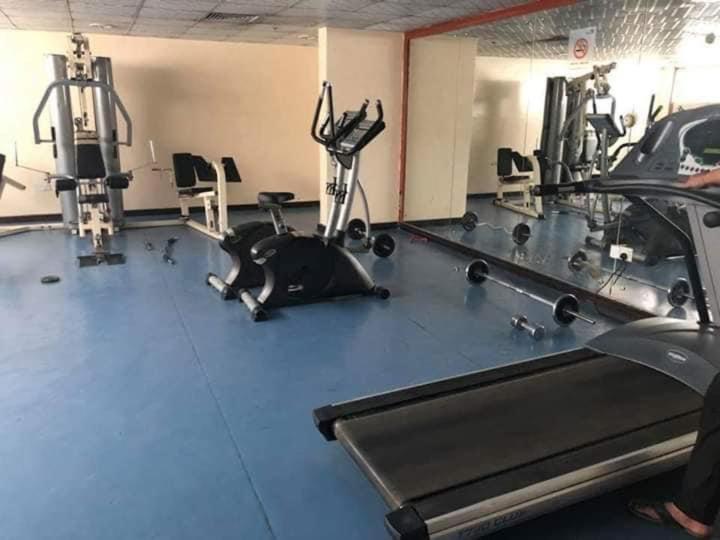 a gym with a dog laying on the floor at Blue house 1 in Dubai