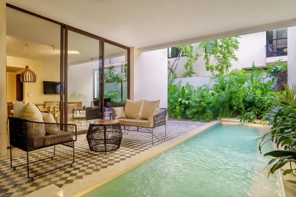 a pool in the middle of a house at Private pool apartment for groups in Tulum