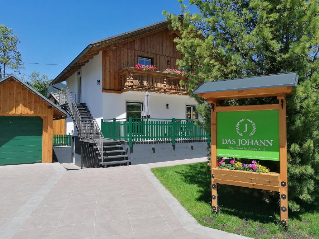 a house with a sign in front of it at DAS JOHANN Apartments im Ausseerland in Bad Aussee