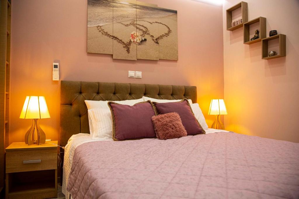 a bedroom with a large bed with purple pillows at Athens Nautical Flat in Piraeus