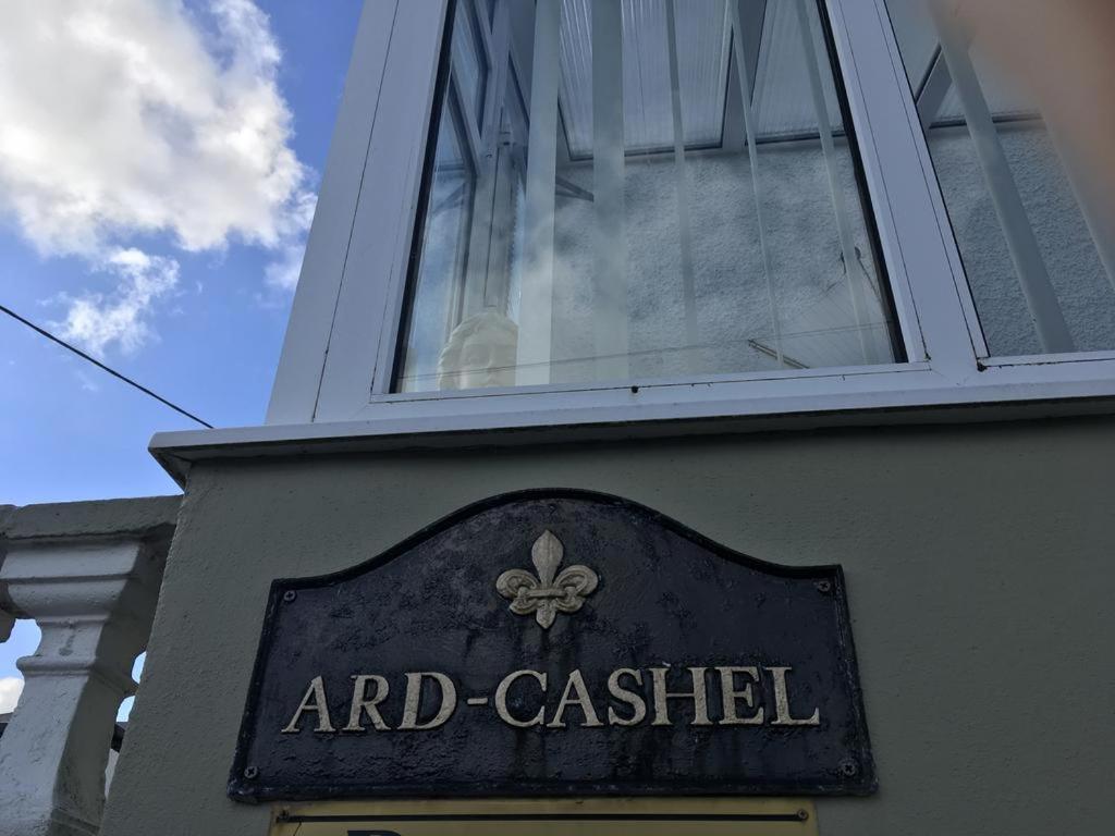 a window on the side of a building with a sign at Ard Cashel in Dungloe