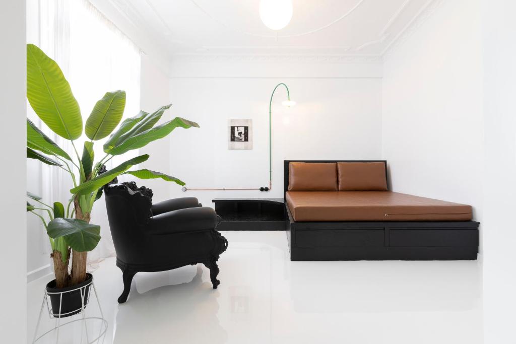 a living room with a couch and a chair at Trilogy Black in Thessaloniki