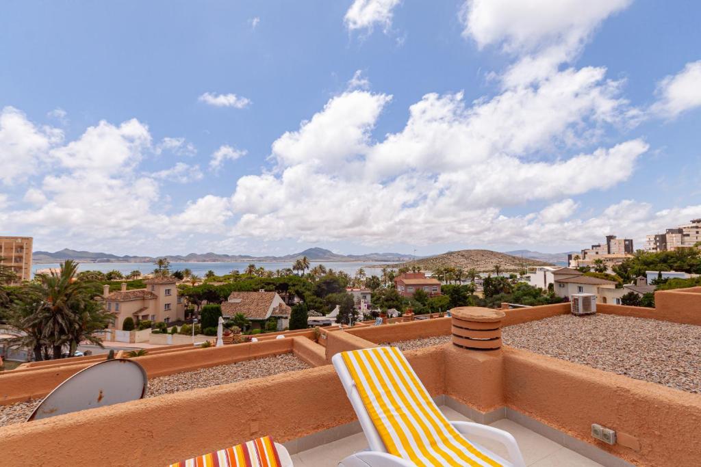 a balcony with chairs and a view of the city at Clipper 309 in La Manga del Mar Menor