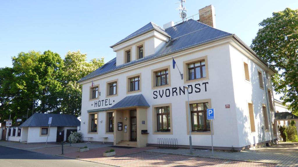 a white building with the words synagog trust on it at Hotel Svornost in Prague