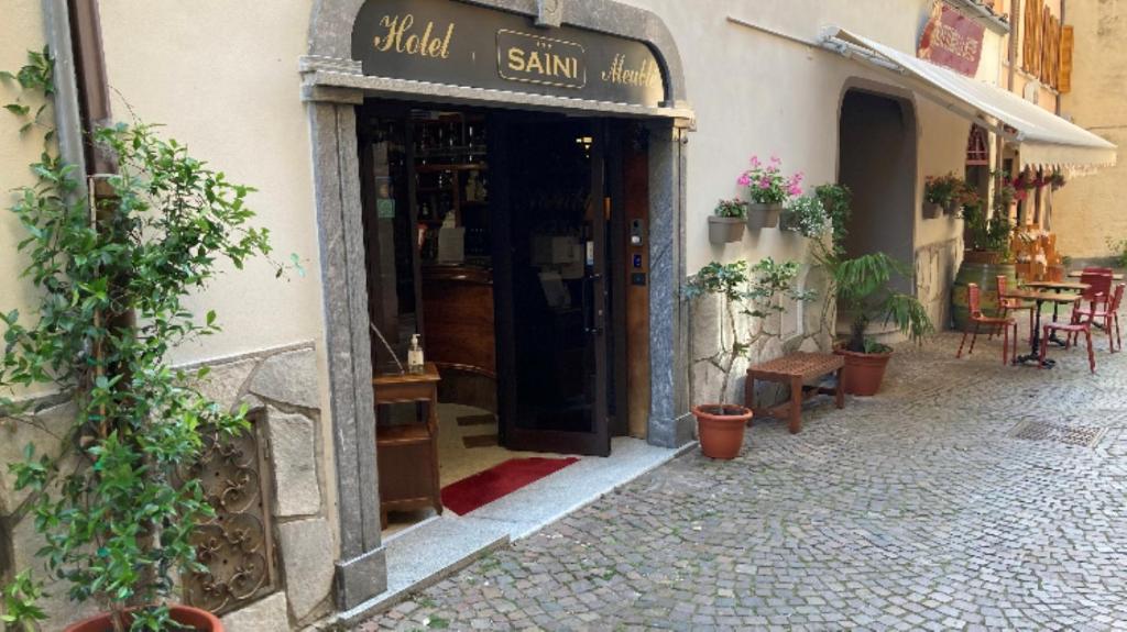 an entrance to a restaurant with tables and chairs at Hotel Saini in Stresa