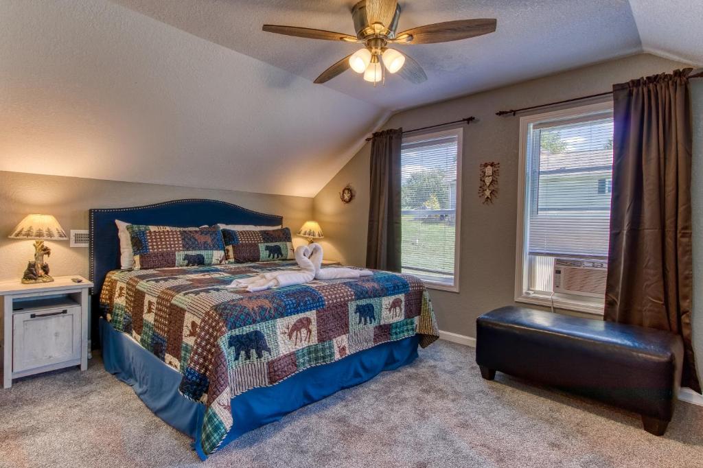 a bedroom with a bed and a ceiling fan at Baby Bear by HoneyBearCabins in Sevierville