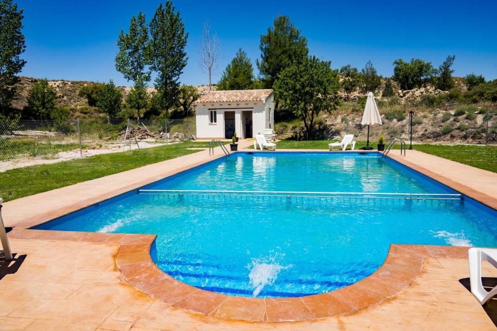 a swimming pool in a yard with a house at El Molino de Batán in Galera