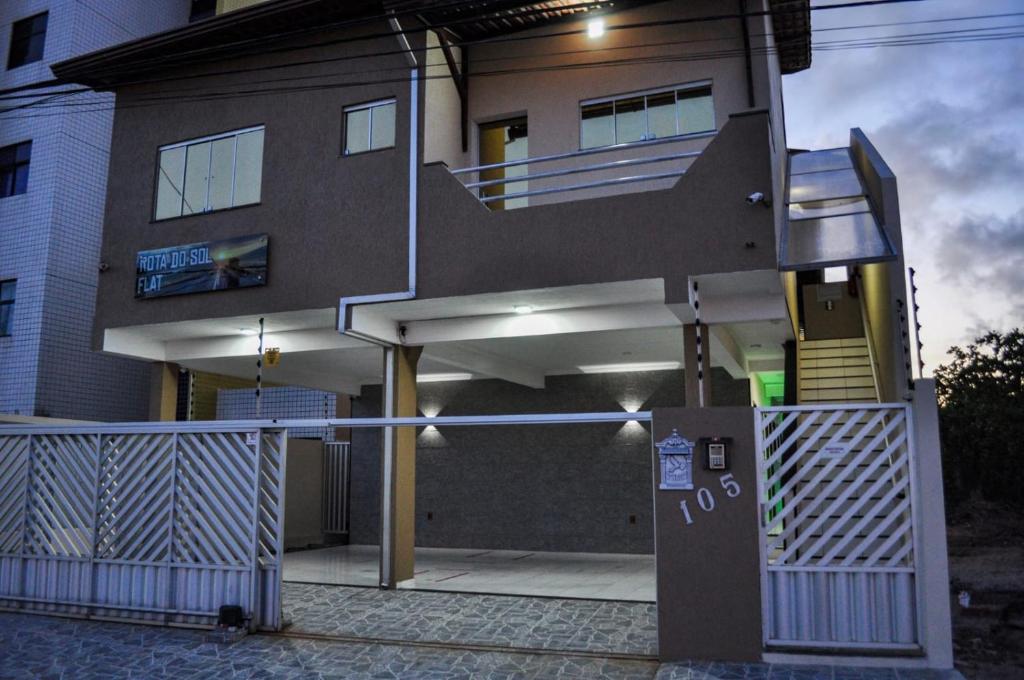 a house with a staircase in front of it at Rota do Sol Flat in Natal