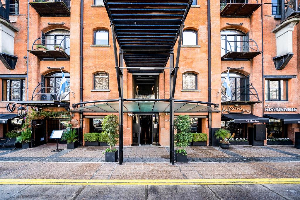 a large brick building with a revolving door in front of it at Madero Homes in Buenos Aires