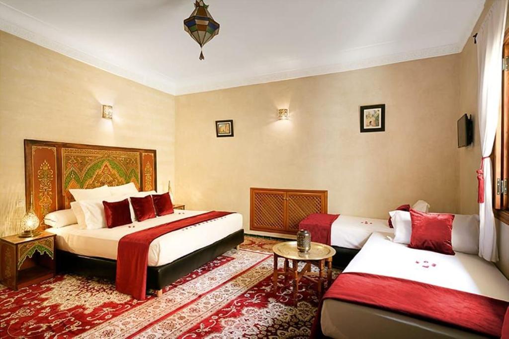 Postel nebo postele na pokoji v ubytování Arabian Riad Marrakech