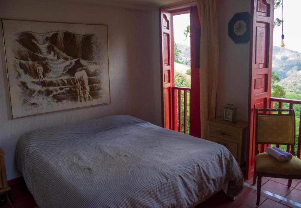 Postel nebo postele na pokoji v ubytování Hotel Natura Cocora
