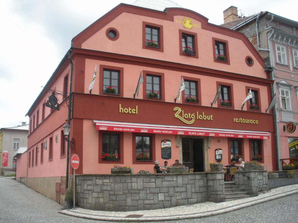 a red building on the side of a street at Hotel Zlatá Labuť in Králíky