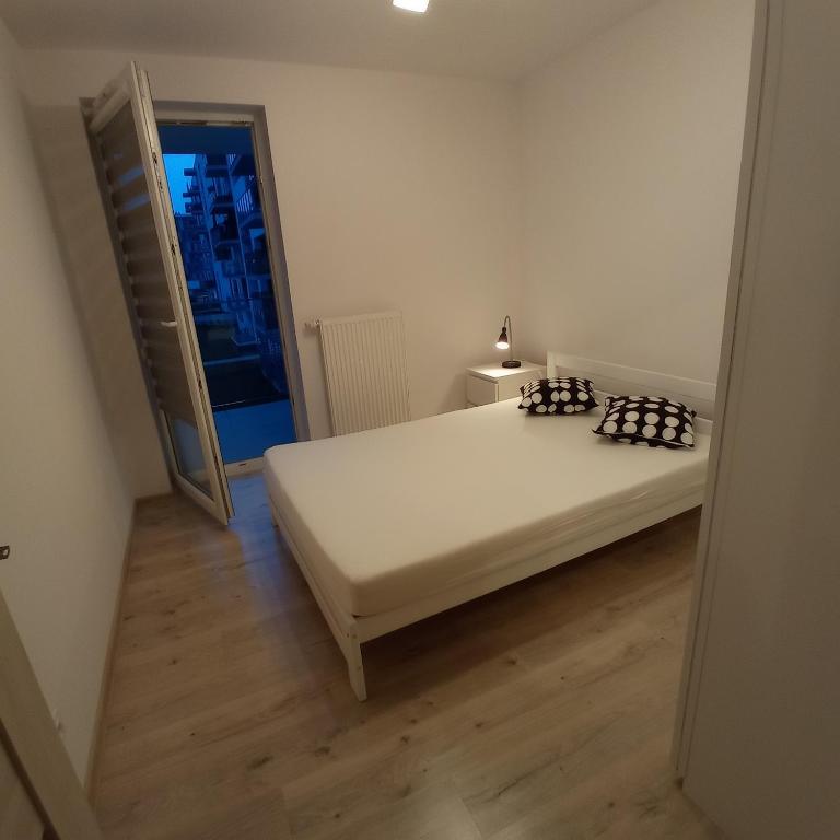 Posteľ alebo postele v izbe v ubytovaní Apartament Ruczaj 2
