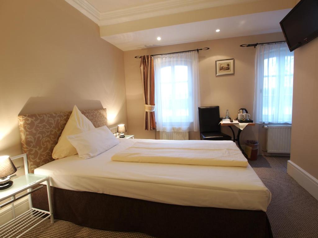 Postel nebo postele na pokoji v ubytování Hotel Am Schloss Biebrich