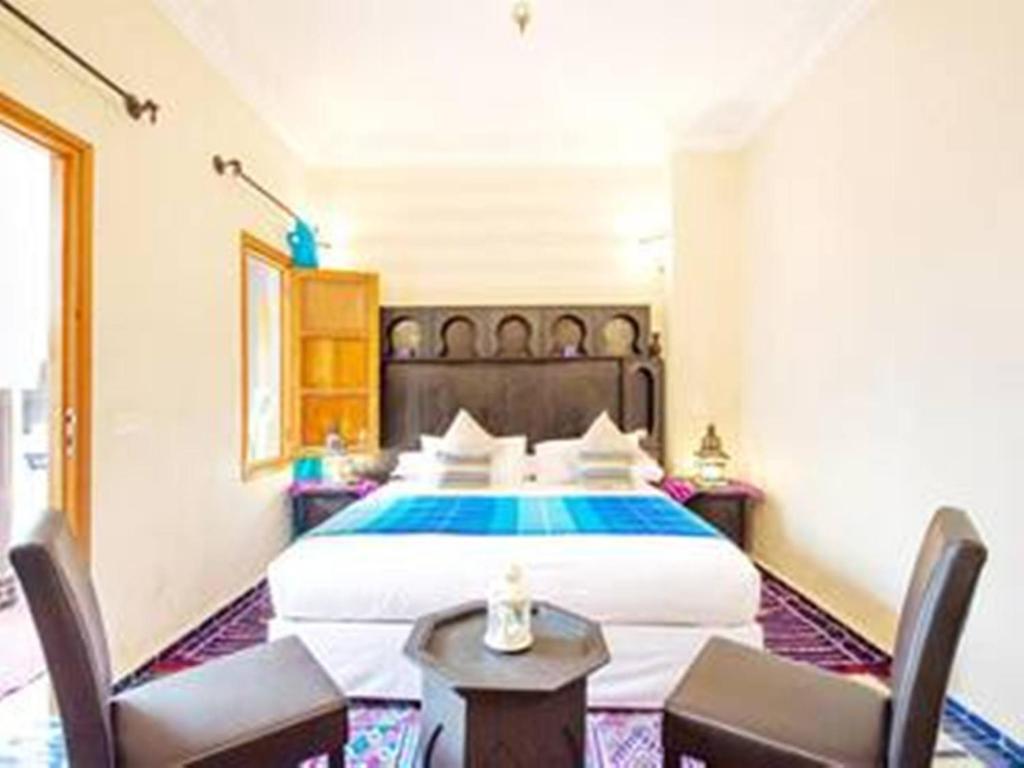 Postel nebo postele na pokoji v ubytování Arabian Riad Marrakech