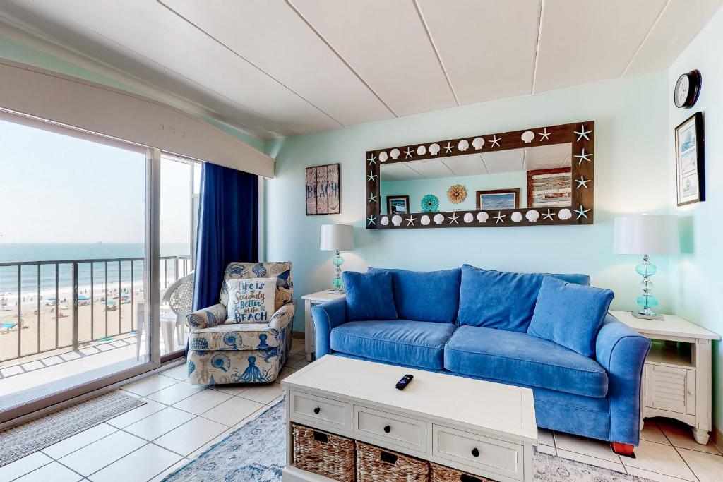 a living room with a blue couch and a window at Decatur House in Ocean City