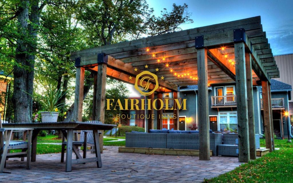 a building with a sign for a restaurant at Fairholm Boutique Inns in Charlottetown