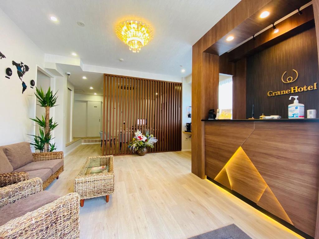 a lobby with a couch and a reception desk at Kiba no Tsuru Carane Hotel - Vacation STAY 09991v in Tokyo