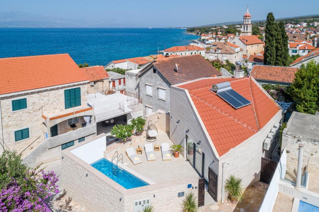 an aerial view of a house with a swimming pool at Villa Stone Pearl in Sutivan