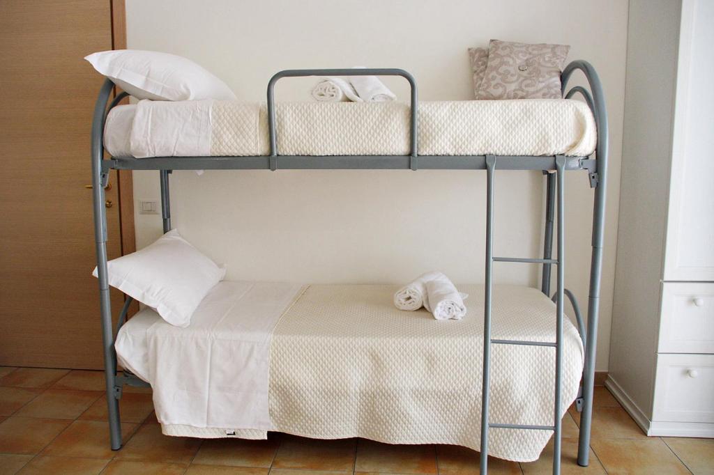 Postel nebo postele na pokoji v ubytování B&B & Residence Pozzo Misseo