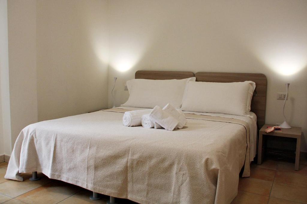 Postel nebo postele na pokoji v ubytování B&B & Residence Pozzo Misseo