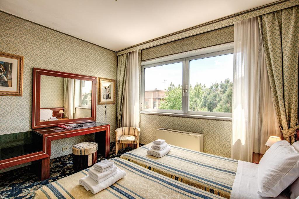 Ліжко або ліжка в номері Venice Michelangelo Hotel