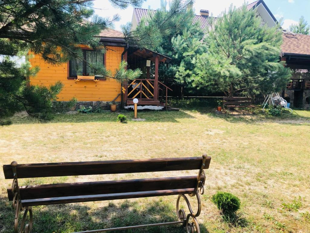 un banco del parque sentado frente a una casa en Казковий Світязь, en Szack