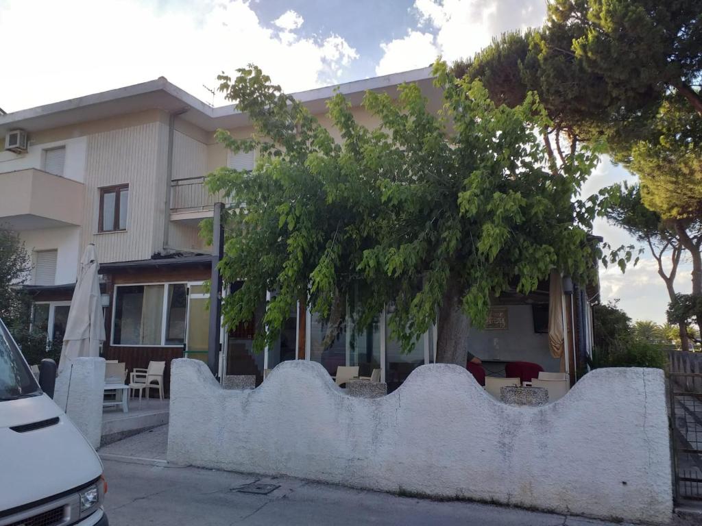 una recinzione bianca di fronte a un edificio di Room in BB - Quadruple room in Pineto - Enjoy a relaxing holiday a Pineto