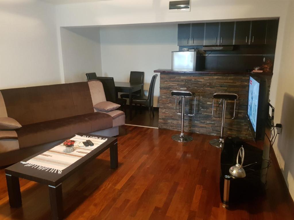 a living room with a couch and a coffee table at Bujic Apartment in Petrovac na Moru