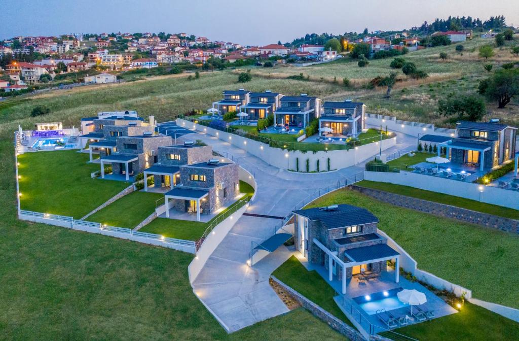 una vista aérea de un grupo de casas azules en Terra Olivia Luxury Villas and Suites, en Paliouri