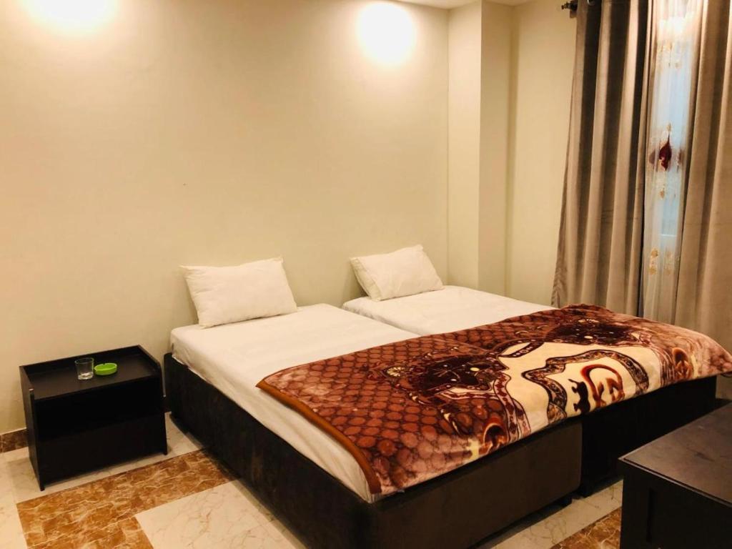 a bedroom with a bed with a tiger blanket at Hotel Silver Oaks in Narān