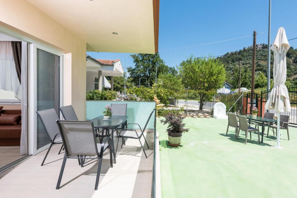 a patio with a table and chairs on a balcony at Villa Laskaridis in Limenas