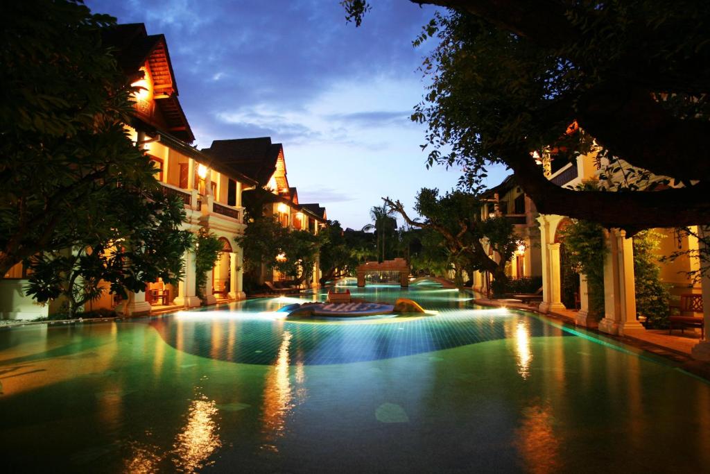 a fountain in the middle of a street at night at Khum Phaya Resort & Spa Boutique Collection in Chiang Mai