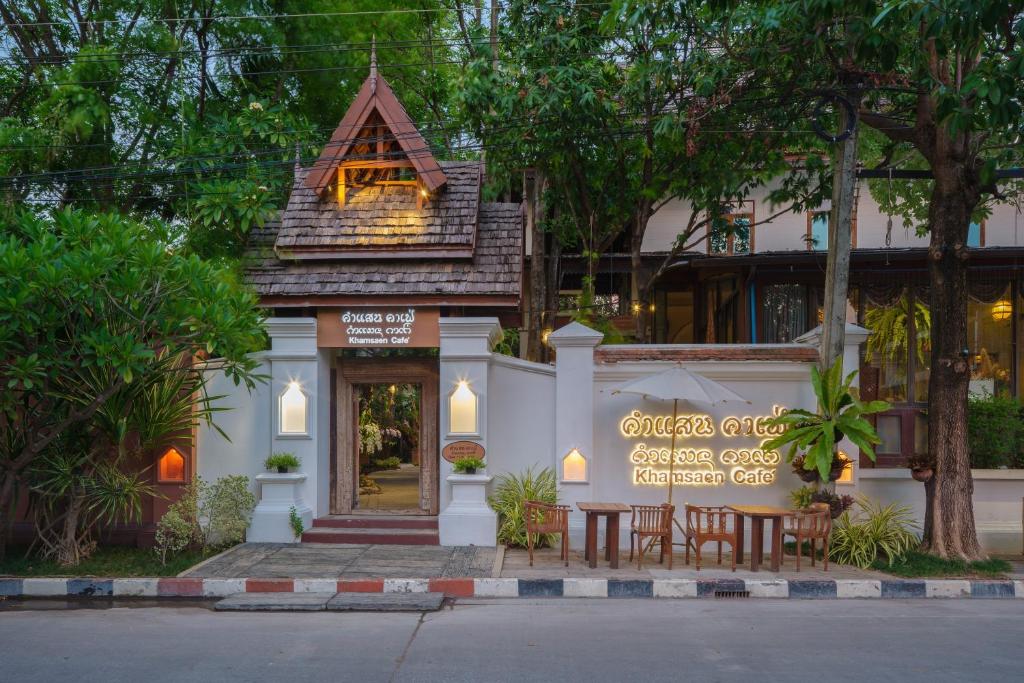 a restaurant with a sign in front of a building at Khum Phaya Resort & Spa Boutique Collection in Chiang Mai