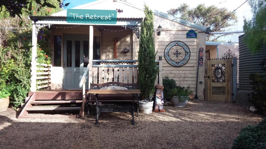 a house with a bench in front of it at A La Folly in Murray Bridge