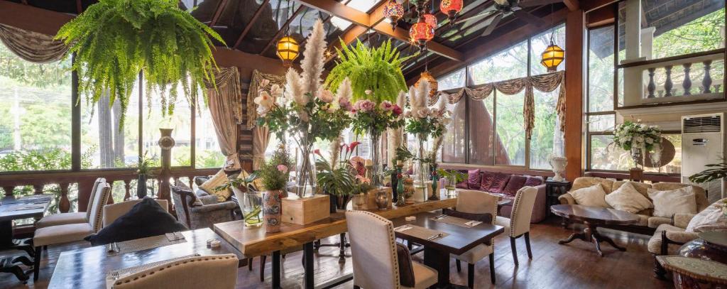 a dining room with a table and chairs at Khum Phaya Resort & Spa Boutique Collection in Chiang Mai