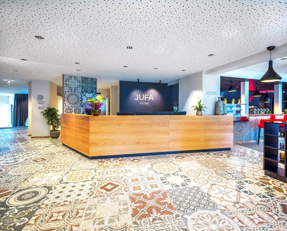 a lobby with a uir sign on a large screen at JUFA Hotel Salzburg City in Salzburg