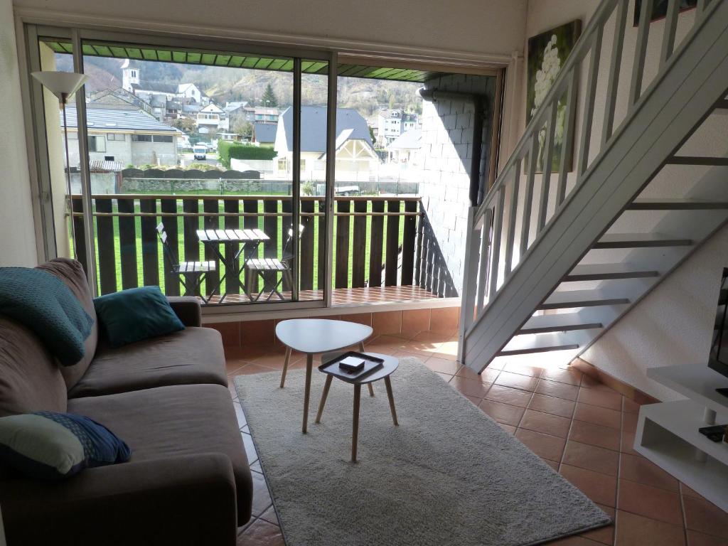 uma sala de estar com um sofá e uma mesa em Appartement LARUNS 2 à 4 personnes em Laruns