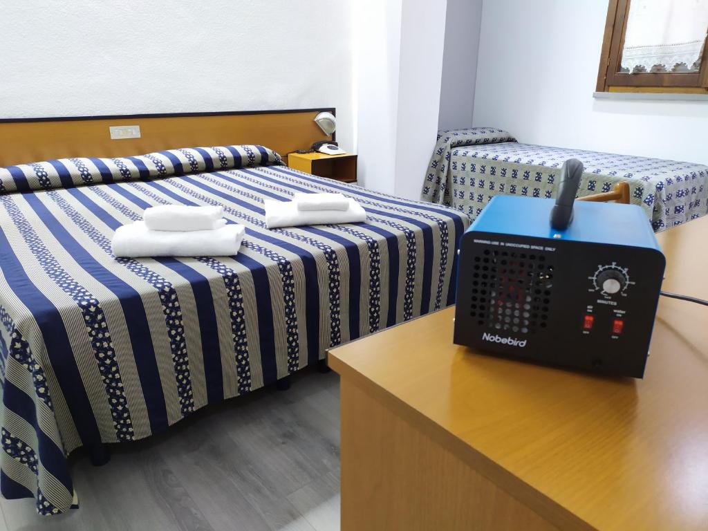 Postel nebo postele na pokoji v ubytování Albergo Martini